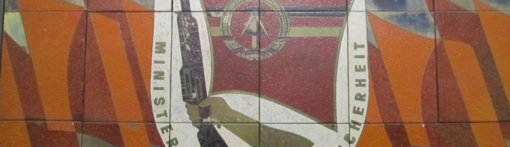 Mural of the Coat of Arms of the (Minsitry for State Security) Stasi just inside the entrance to the building.